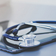 UNINE_FD_IDS_vignette.jpg (Medical equipment: blue stethoscope and tablet on white background)